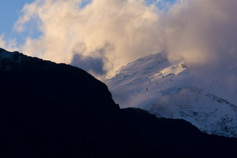 Glacier Through Clouds At Sunset
